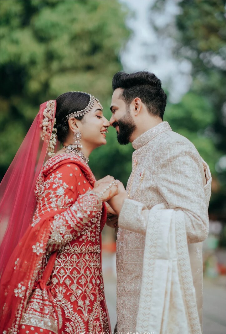 South Asian wedding couple sharing a joyful portrait