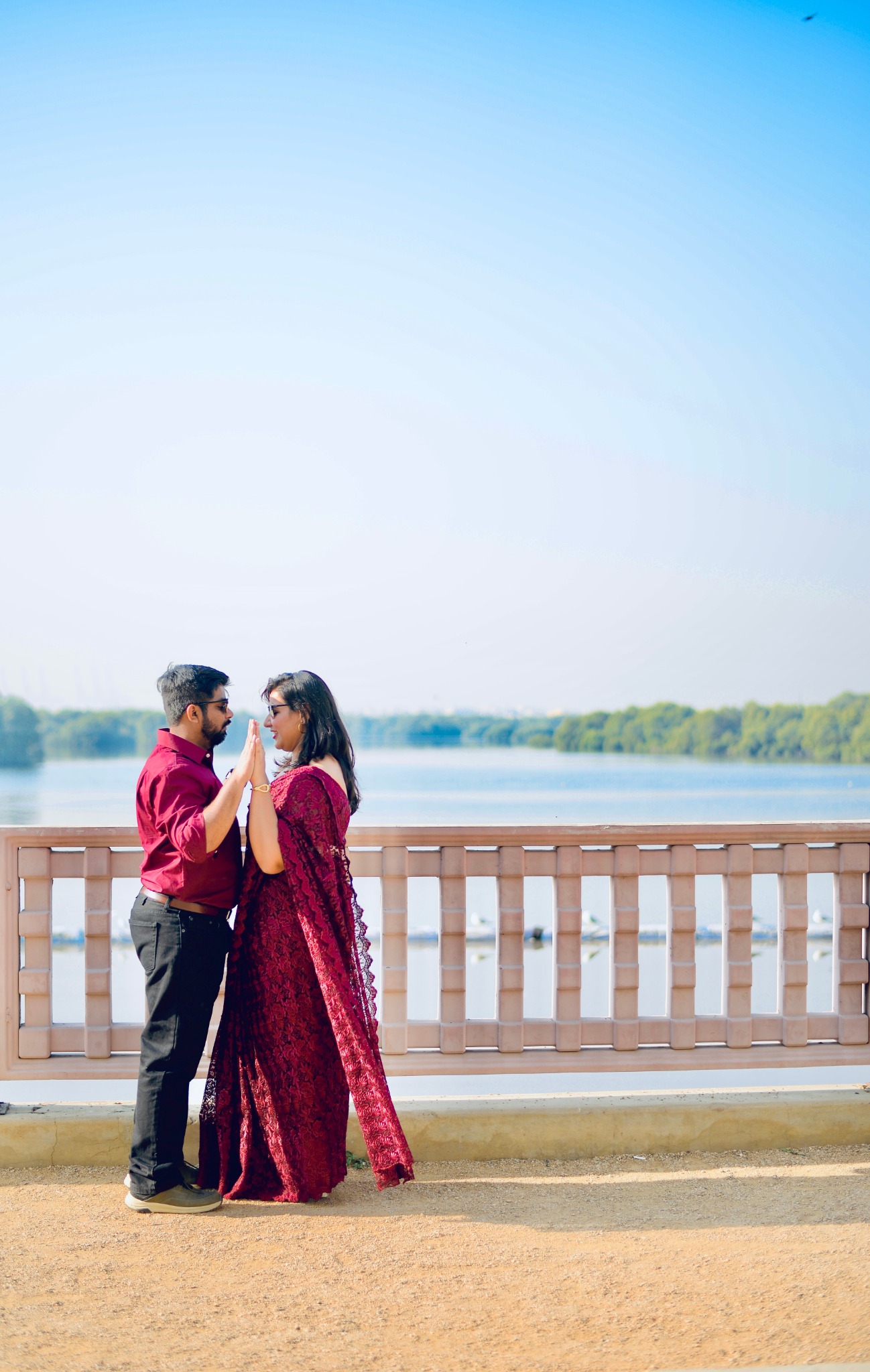 Couple celebrating together beside a lake